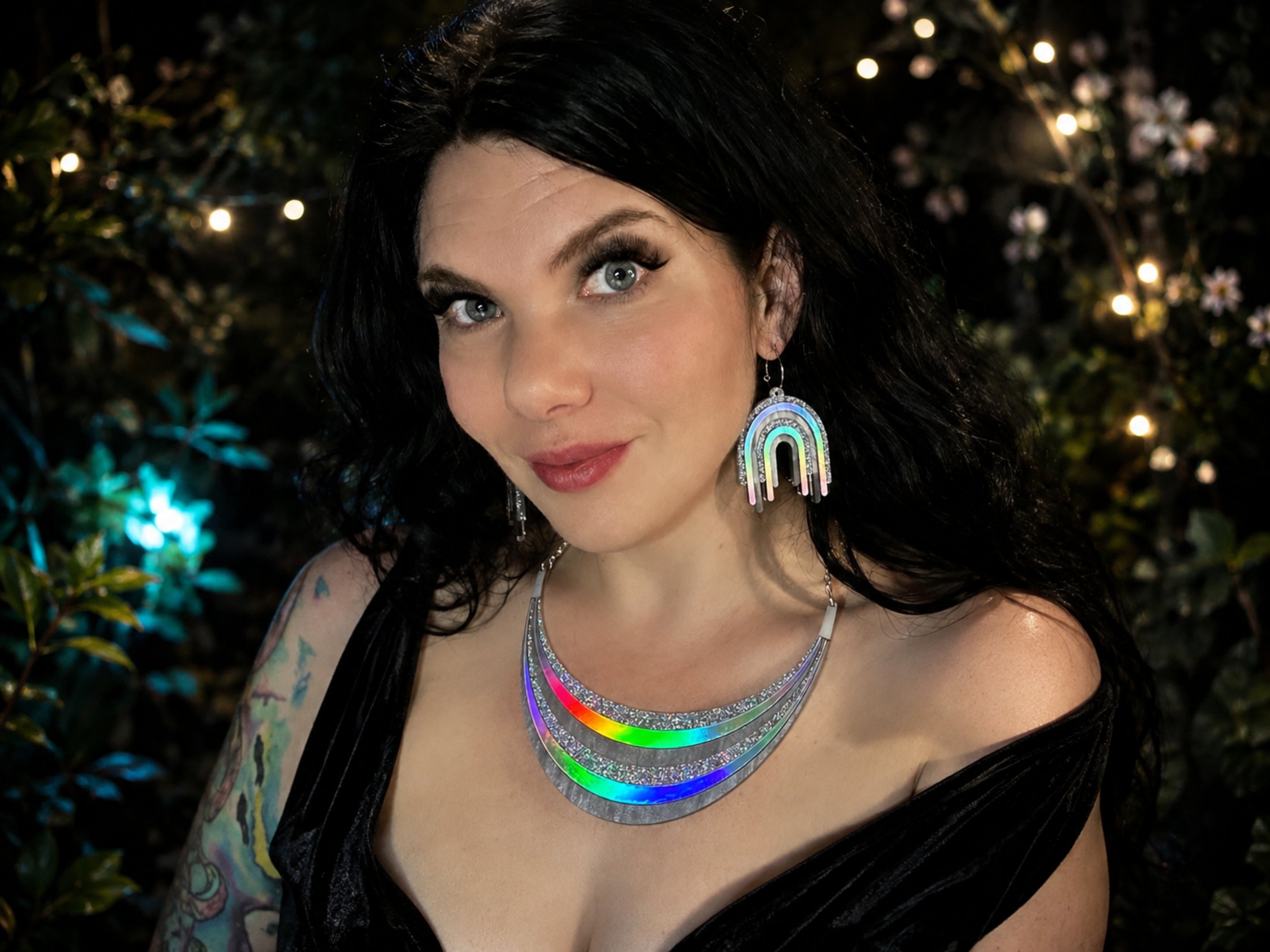 Model wearing the Full Spectrum Rebel Disco Prism necklace and earrings with silver holographic rainbow details.