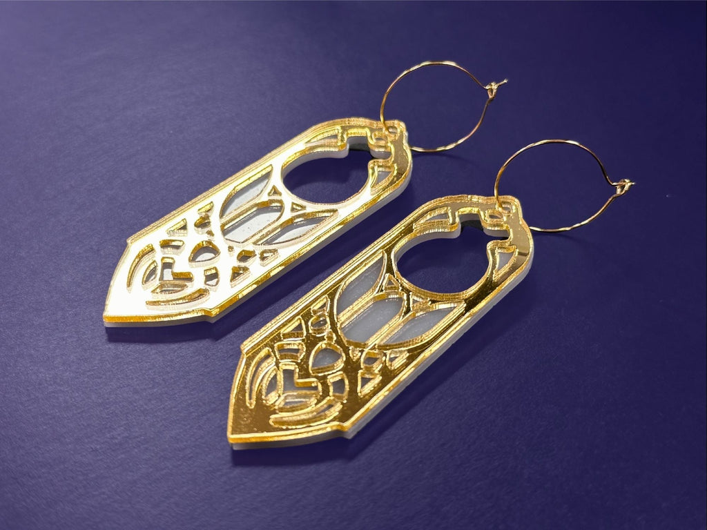 Gold mirror Sunforged Arwen statement earrings photographed on deep purple background