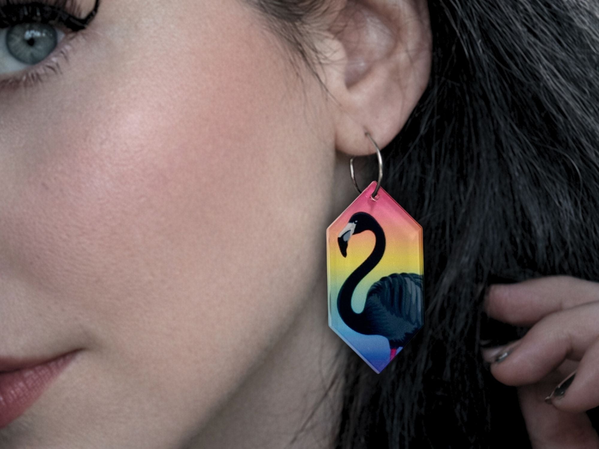 Woman wearing Rainbow Sundown black flamingo statement earrings
