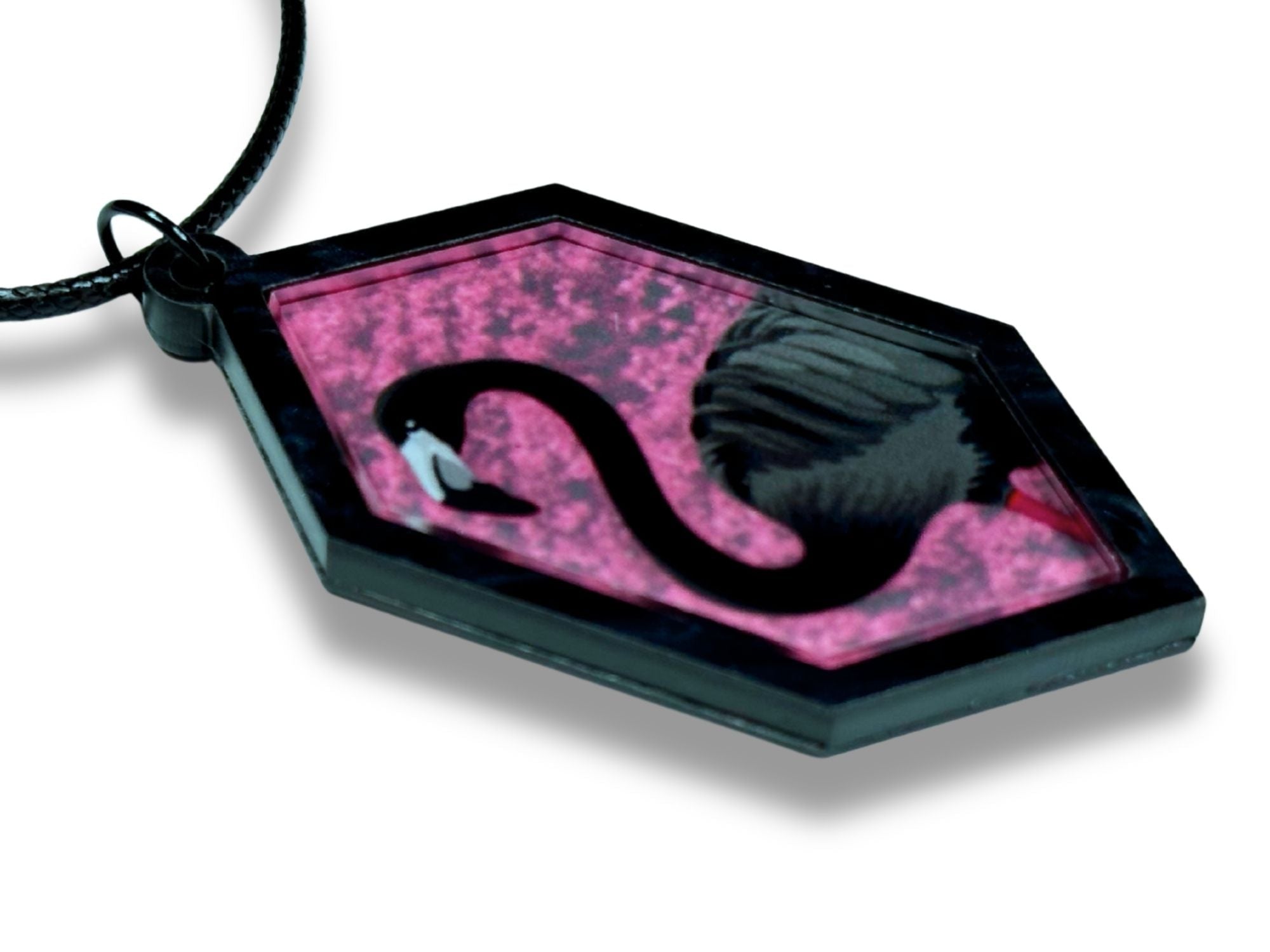 Side angle of layered black flamingo pendant showing acrylic depth