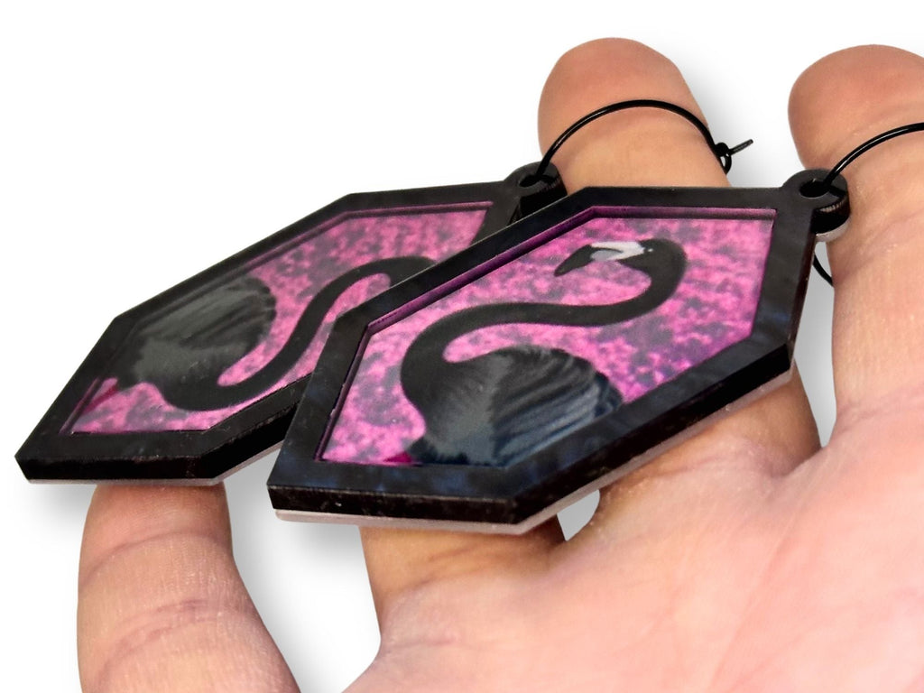 Side view of layered flamingo acrylic earrings showing thickness and depth