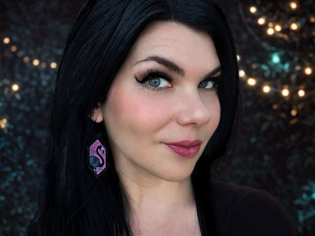 Woman wearing Arcadia Pink flamingo statement earrings
