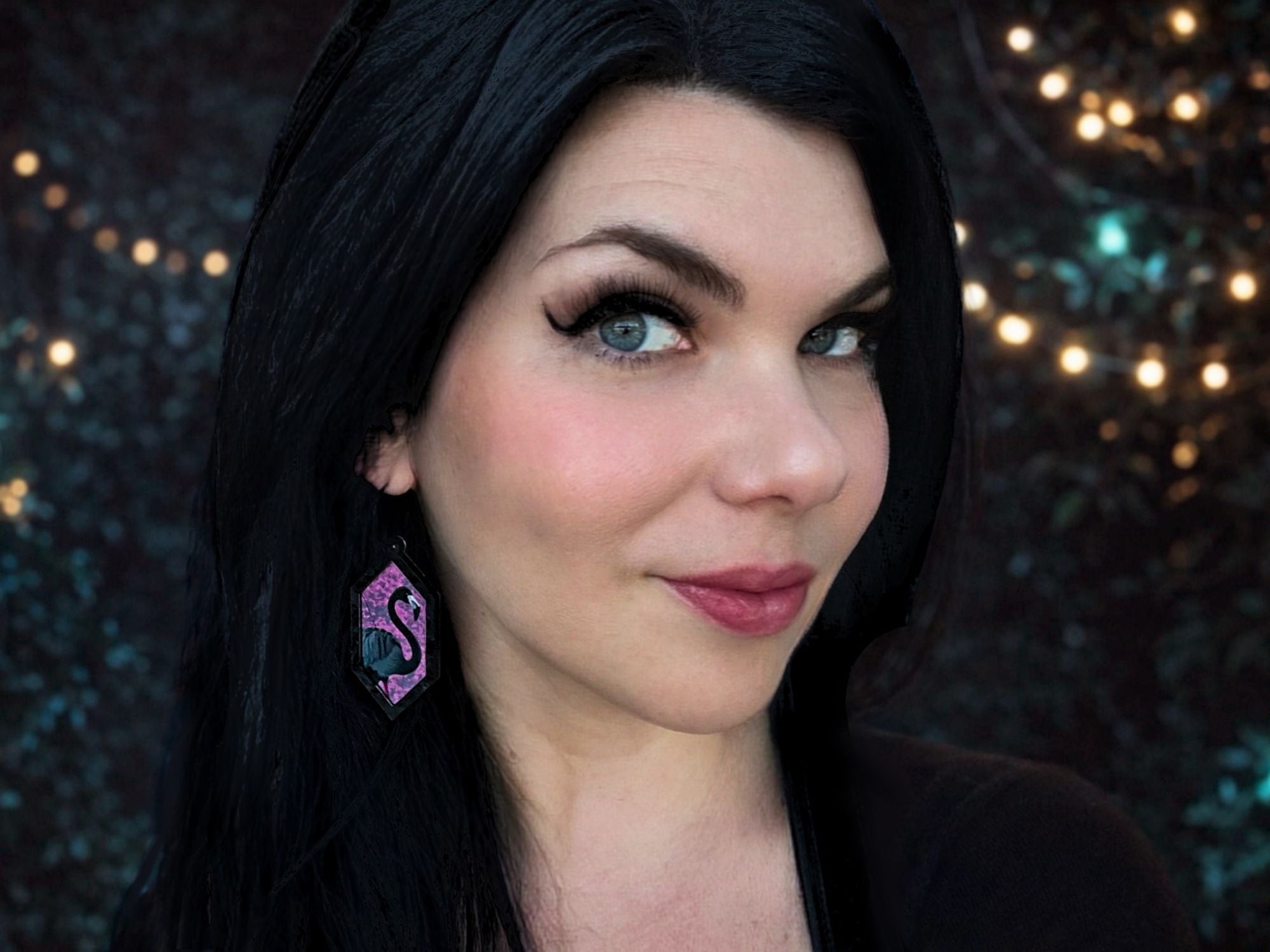 Woman wearing Arcadia Pink flamingo statement earrings