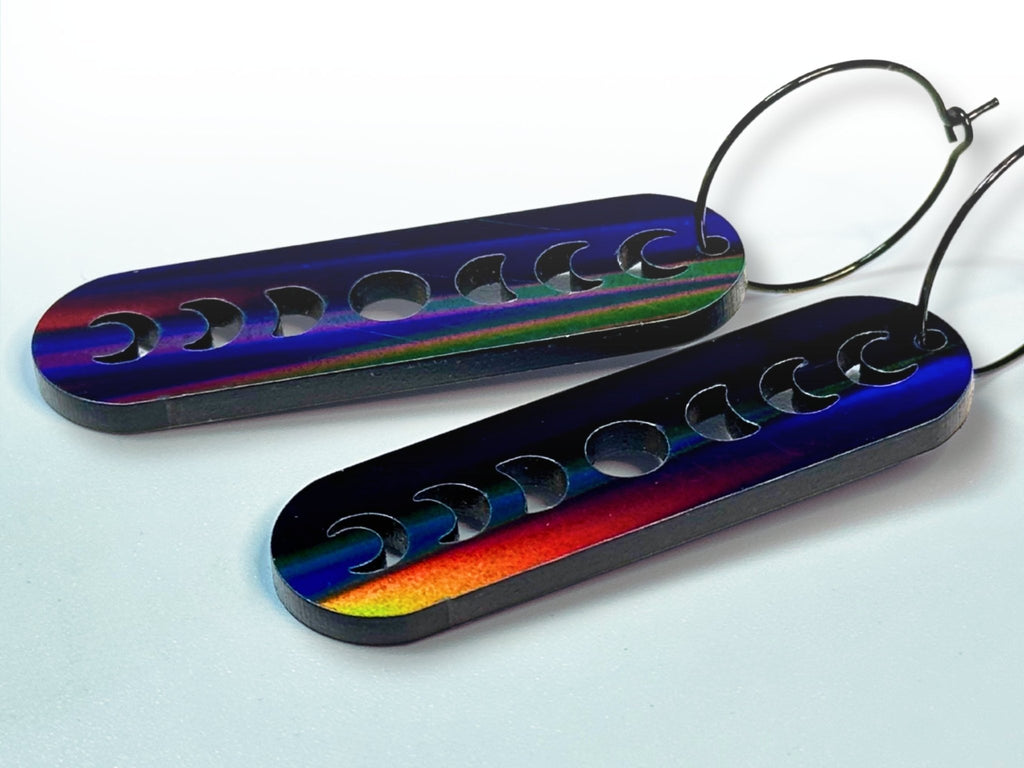 Side view of Black Magic iridescent moon phase earrings showing color-shifting finish