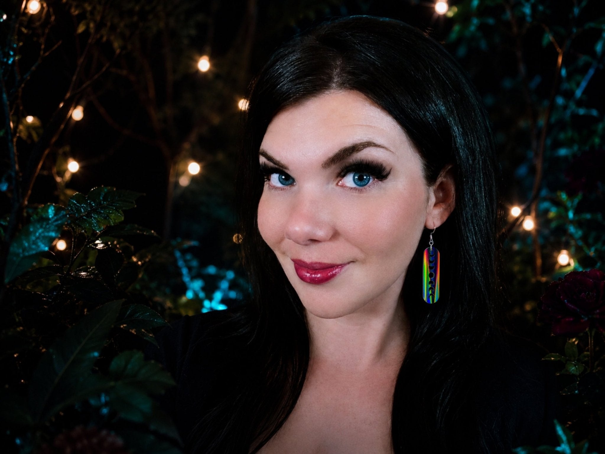 Black Magic moon phase statement earring worn on model