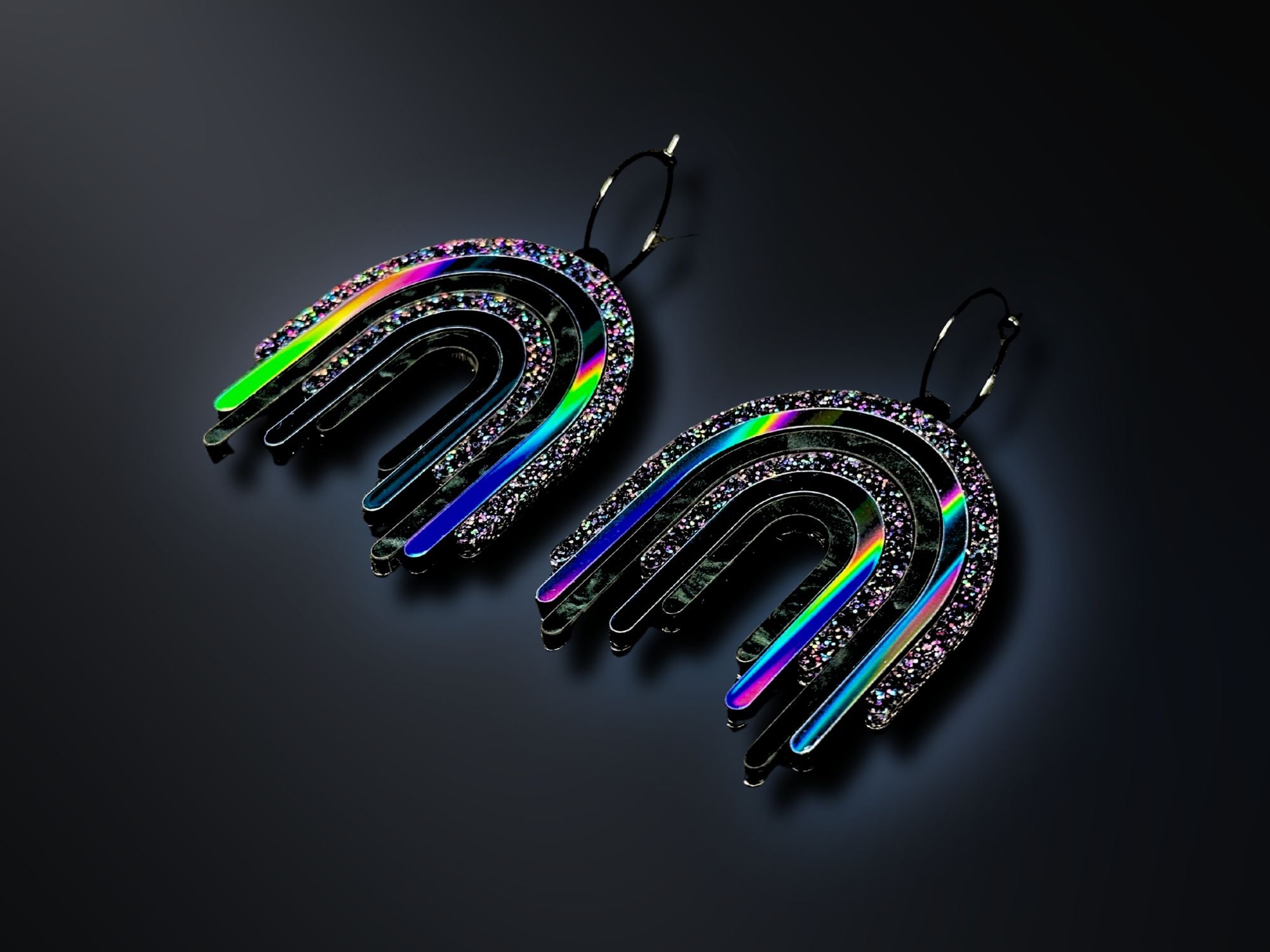 Black Rainbow Drip Earrings photographed on dark background