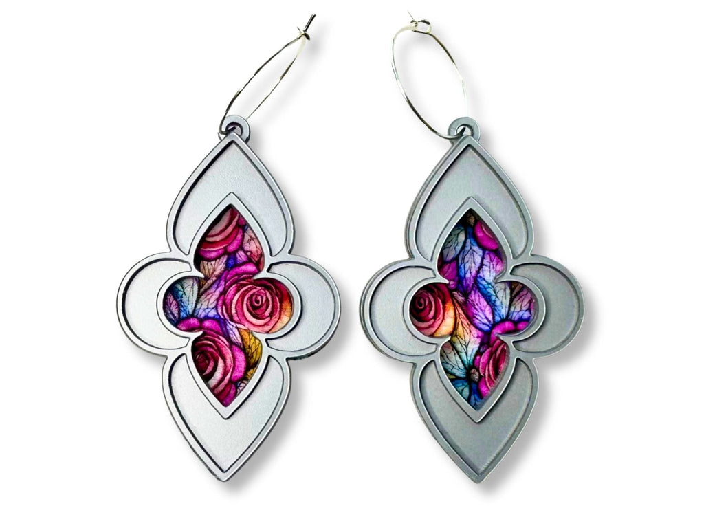 Metallic silver stained glass cathedral earrings with pink rose artwork on white background