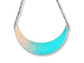Iridescent glow-in-the-dark crescent moon collar necklace on white background