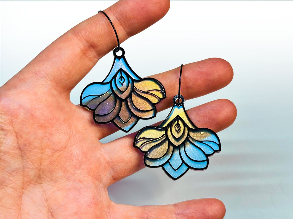 Hand holding Deco Bloom earrings showing size and scale