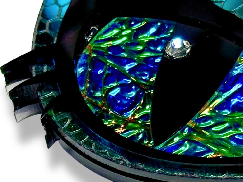 close up of dichrolam dragon eye necklace showing color shifting iris and crystal pupil detail