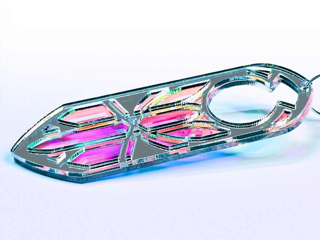 Iridescent acrylic Disa statement earrings with silver mirror detailing on soft gradient background