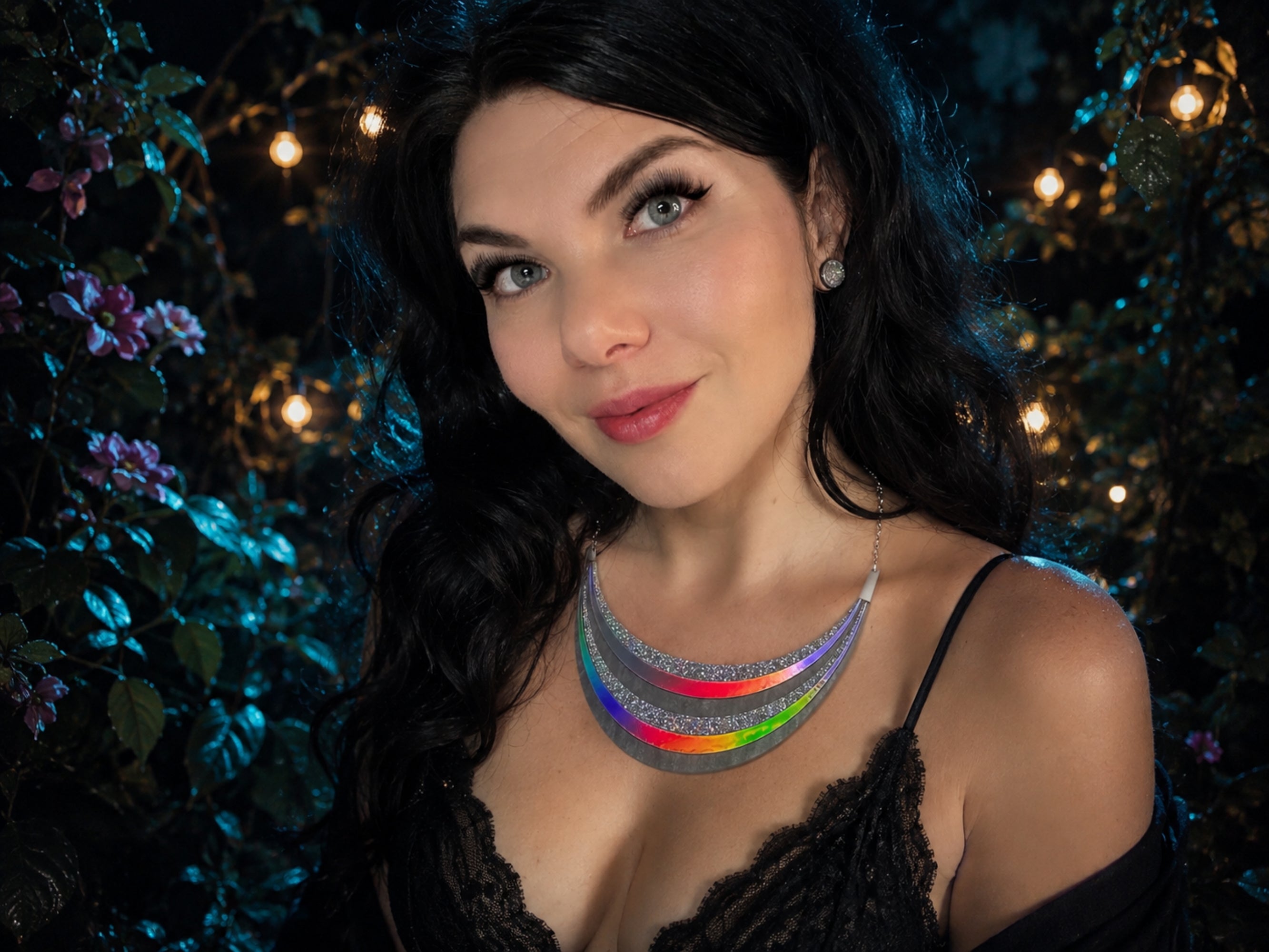 Model wearing the Disco Prism arc statement necklace with layered silver, holographic glitter, and iridescent rainbow arcs.