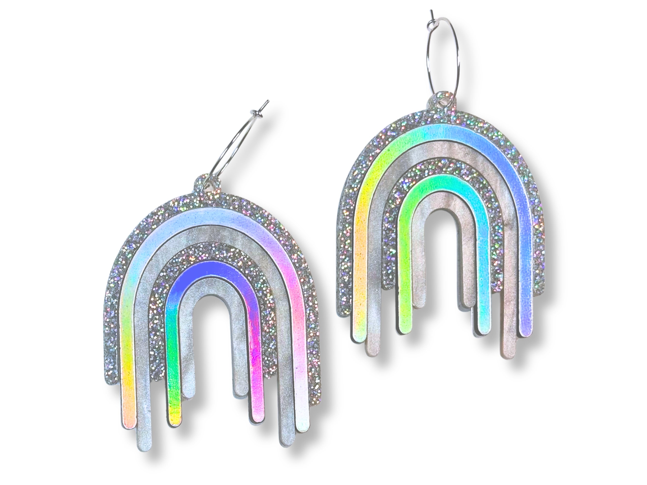 Disco Prism drip earrings with layered silver, holographic glitter, and iridescent rainbow arcs on a white background.