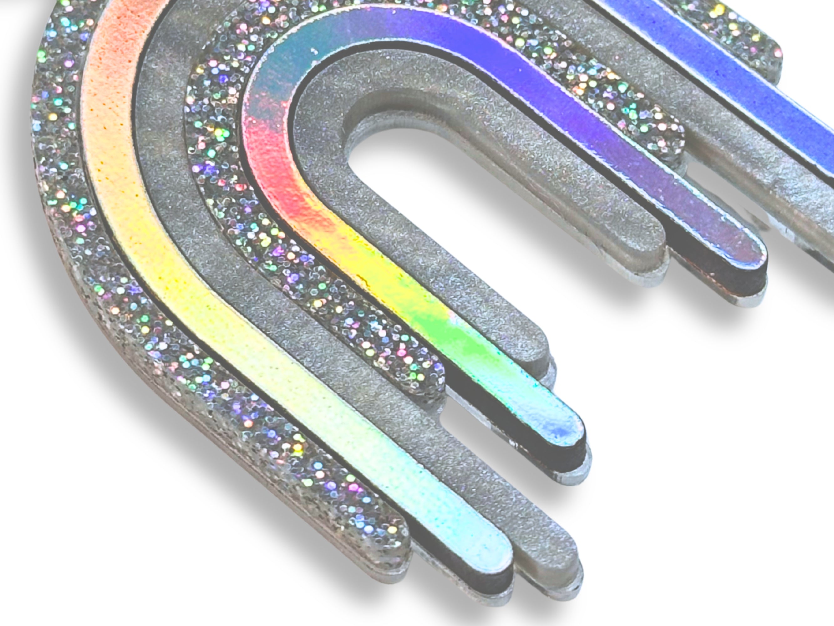 Close-up of Disco Prism earring layers showing metallic silver, holographic glitter, and color-shifting iridescent details.