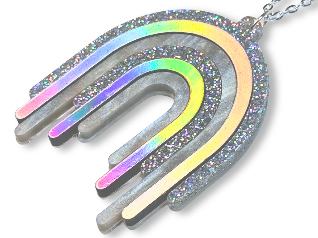 Close-up of Disco Prism pendant showing layered holographic rainbow, metallic silver and multicolor glitter finishes.