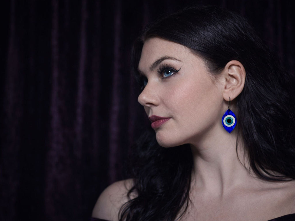 evil eye statement earrings worn on model bold talisman jewelry layered acrylic styling