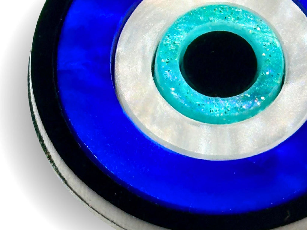layered construction of evil eye pendant necklace showing dimensional acrylic design detail blue white black