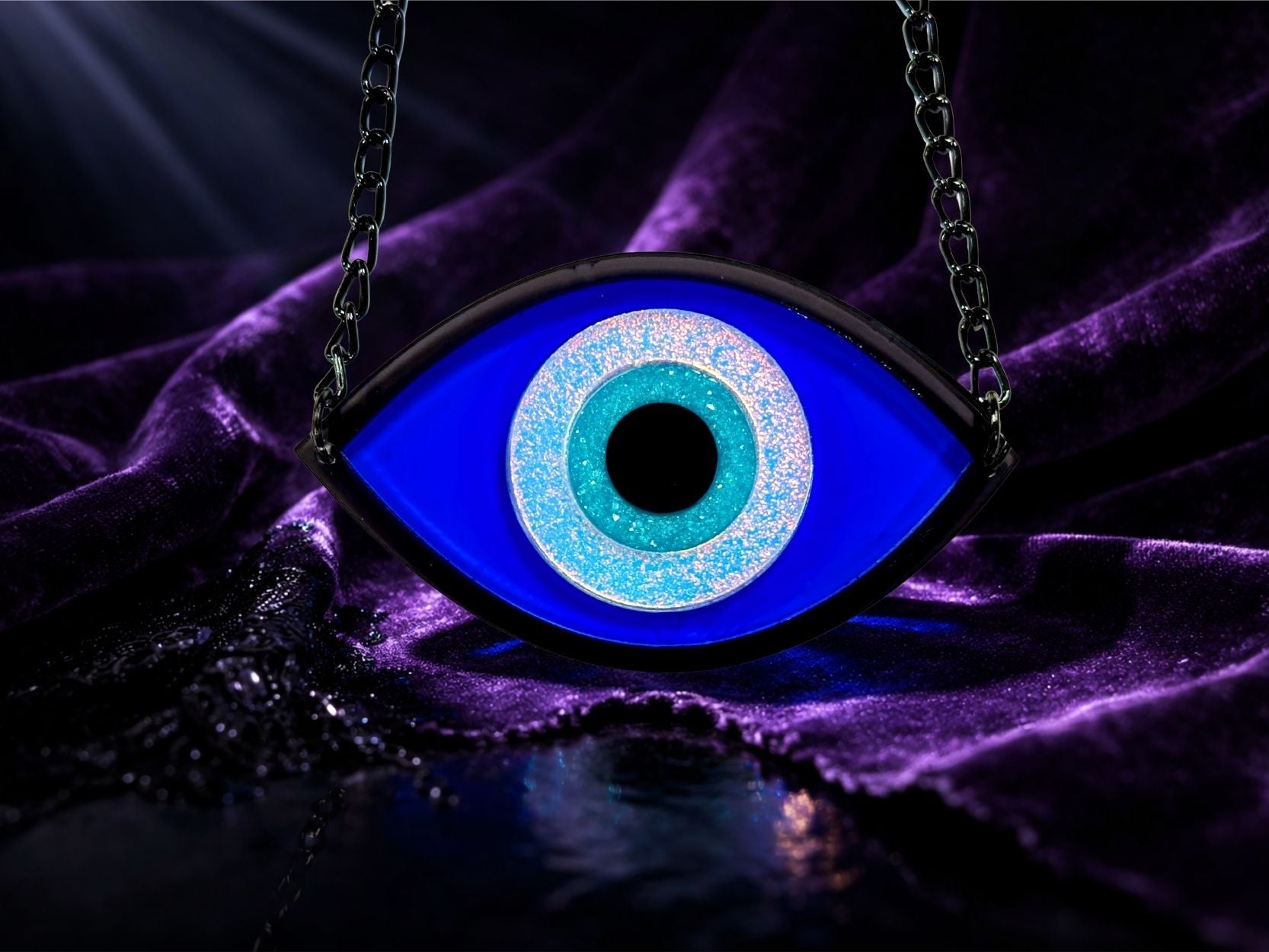 evil eye necklace styled flatlay iridescent talisman jewelry mythic aesthetic bold design