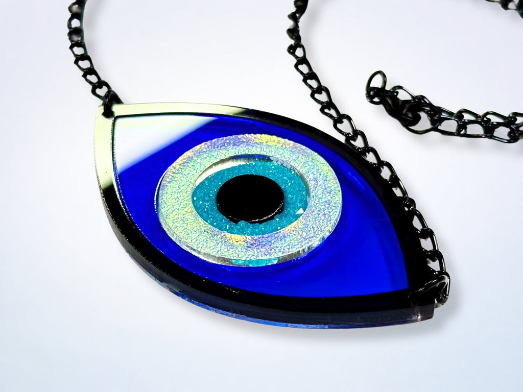 evil eye necklace styled flatlay iridescent talisman jewelry mythic aesthetic bold design