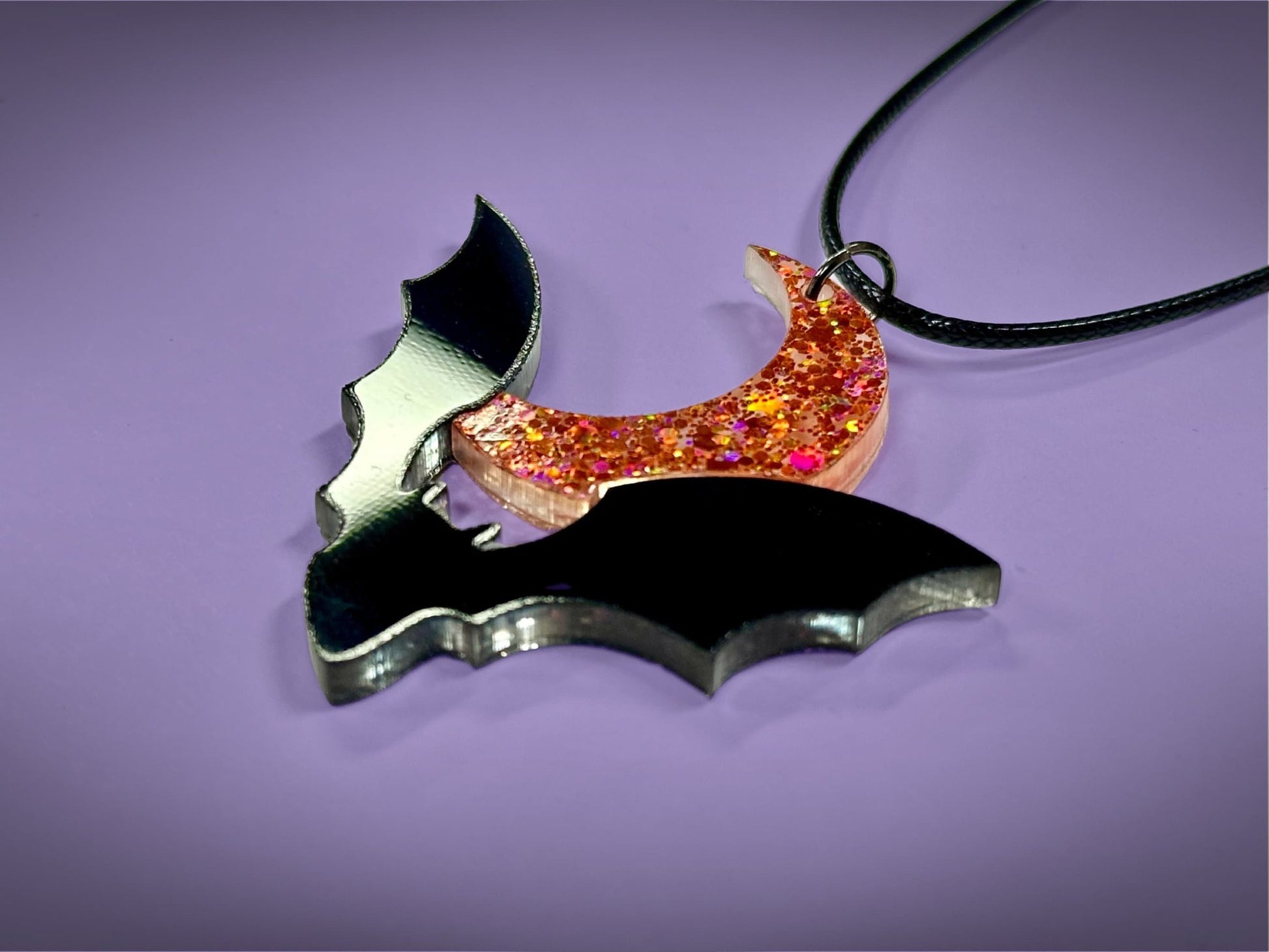 Flying Bat and Crescent Moon Pendant | Black and Holographic Harvest Orange Glitter Halloween Necklace - Painted Raina