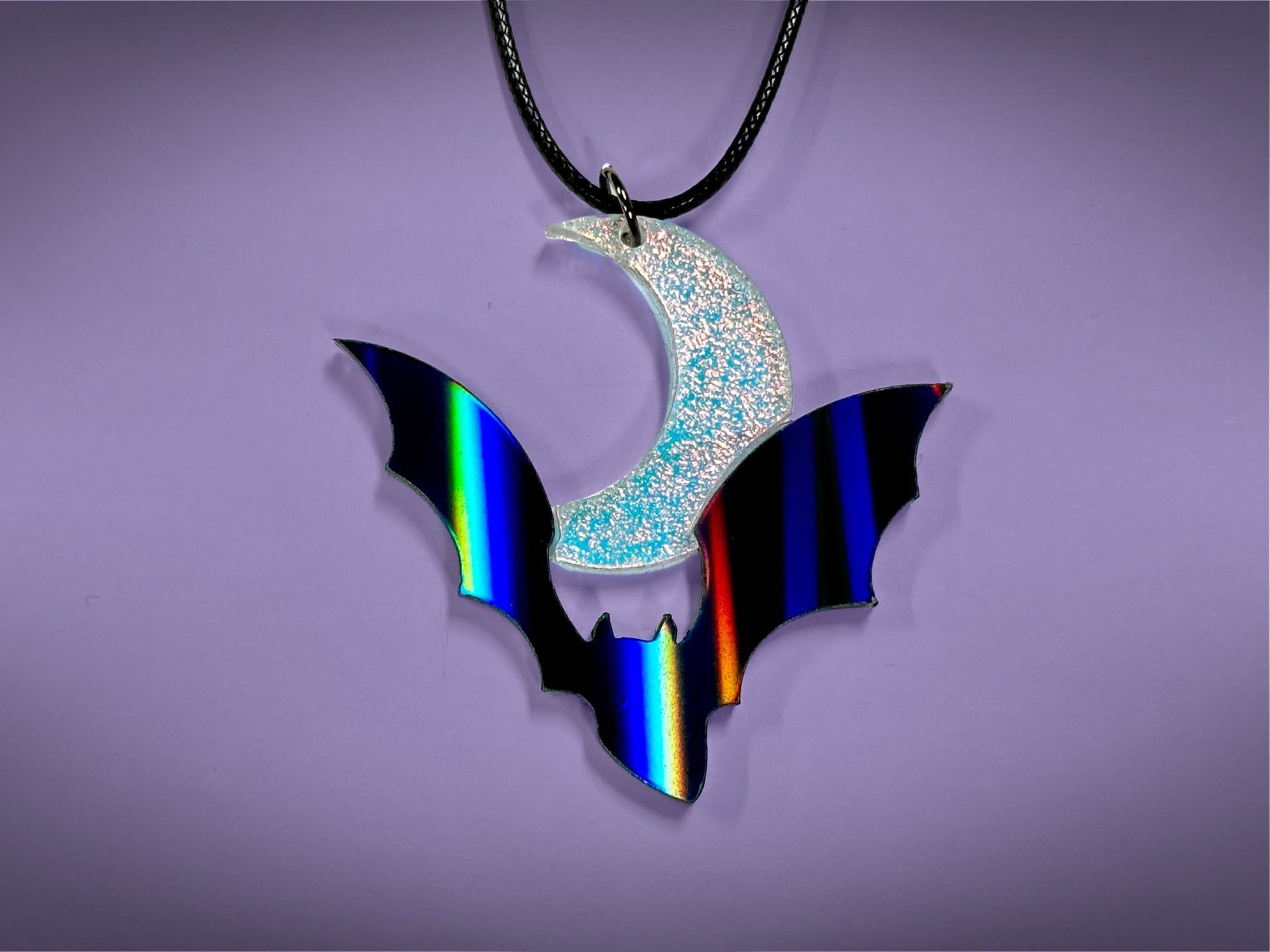 Flying Bat and Crescent Moon Pendant | Black Rainbow Holographic and Textured Iridescent Halloween Necklace - Painted Raina