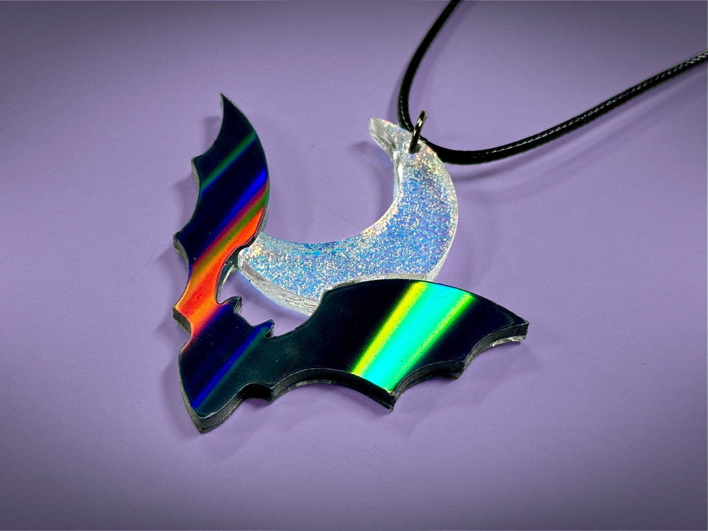 Flying Bat and Crescent Moon Pendant | Black Rainbow Holographic and Textured Iridescent Halloween Necklace - Painted Raina