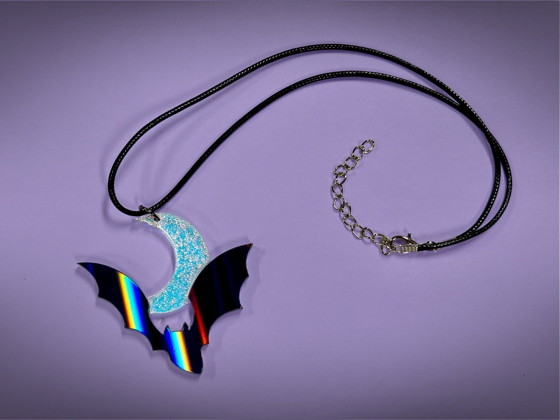 Flying Bat and Crescent Moon Pendant | Black Rainbow Holographic and Textured Iridescent Halloween Necklace - Painted Raina