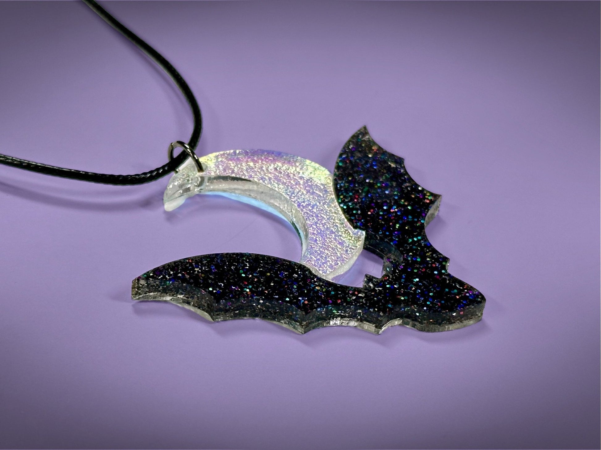 Flying Bat and Crescent Moon Pendant | Black Rainbow Holographic Glitter & Textured Iridescent Halloween Necklace - Painted Raina