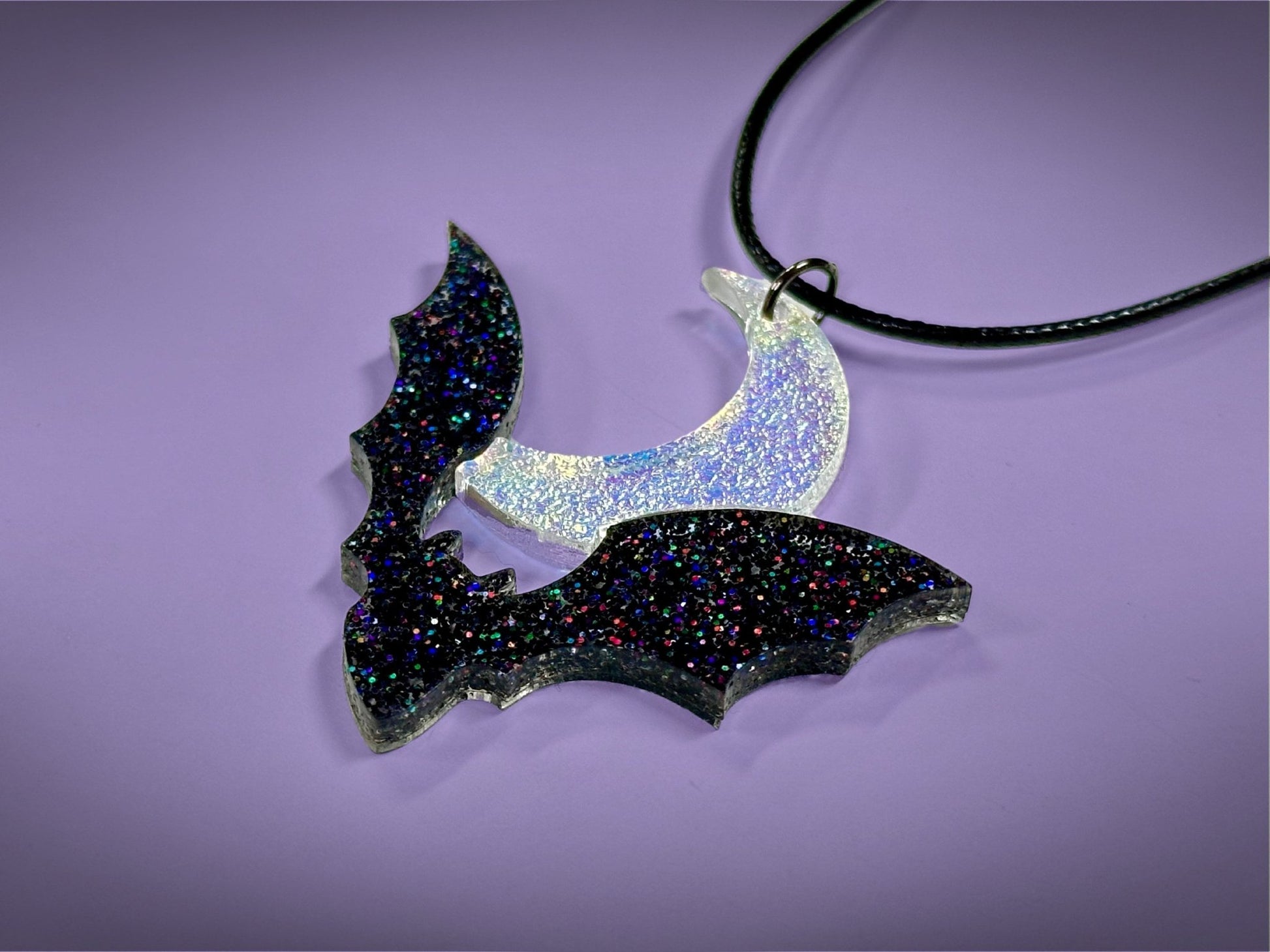 Flying Bat and Crescent Moon Pendant | Black Rainbow Holographic Glitter & Textured Iridescent Halloween Necklace - Painted Raina