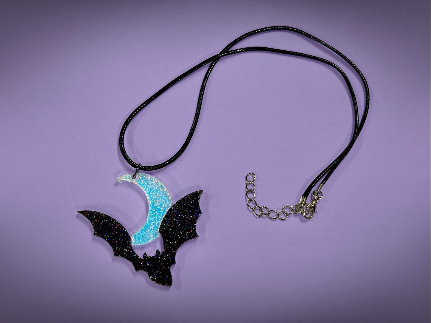 Flying Bat and Crescent Moon Pendant | Black Rainbow Holographic Glitter & Textured Iridescent Halloween Necklace - Painted Raina