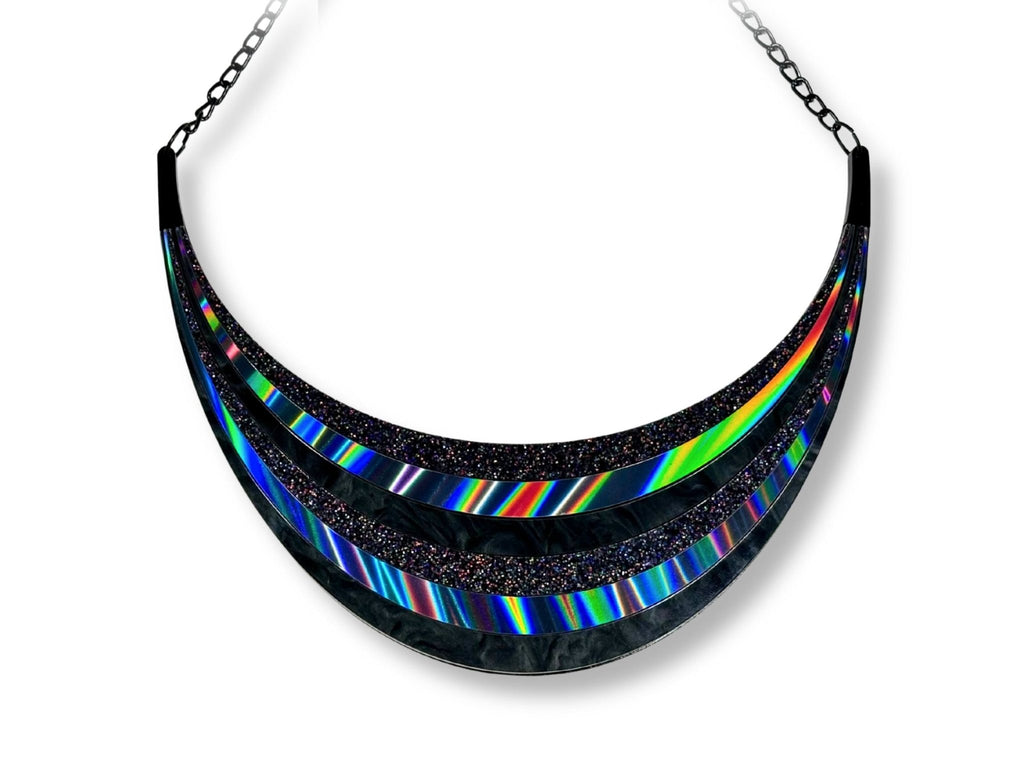 Full Spectrum Rebel Arc Statement Necklace in layered black rainbow acrylic on white background