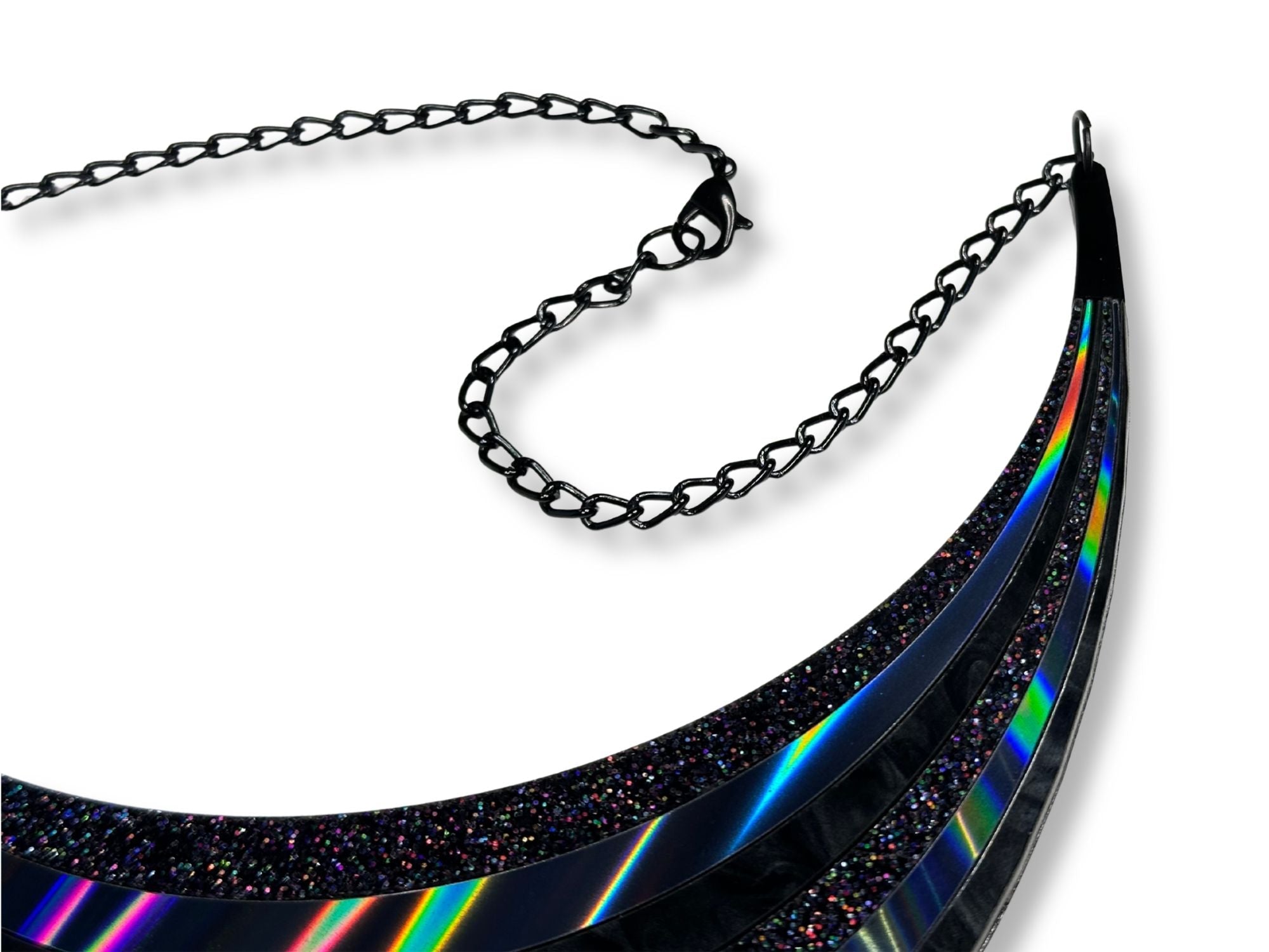 Close-up of black-plated chain and glossy black necklace accents