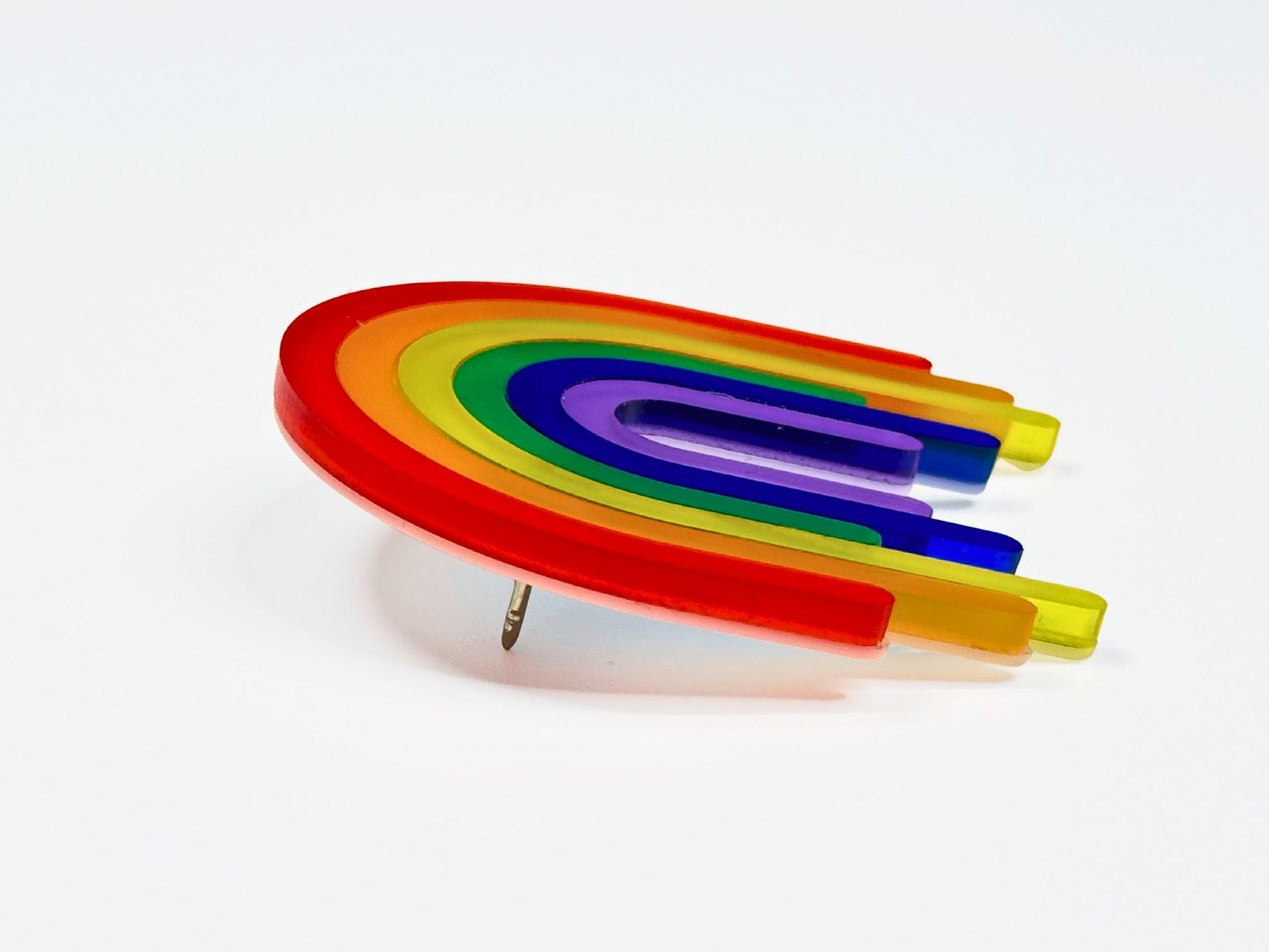 Side angle view of layered rainbow acrylic brooch