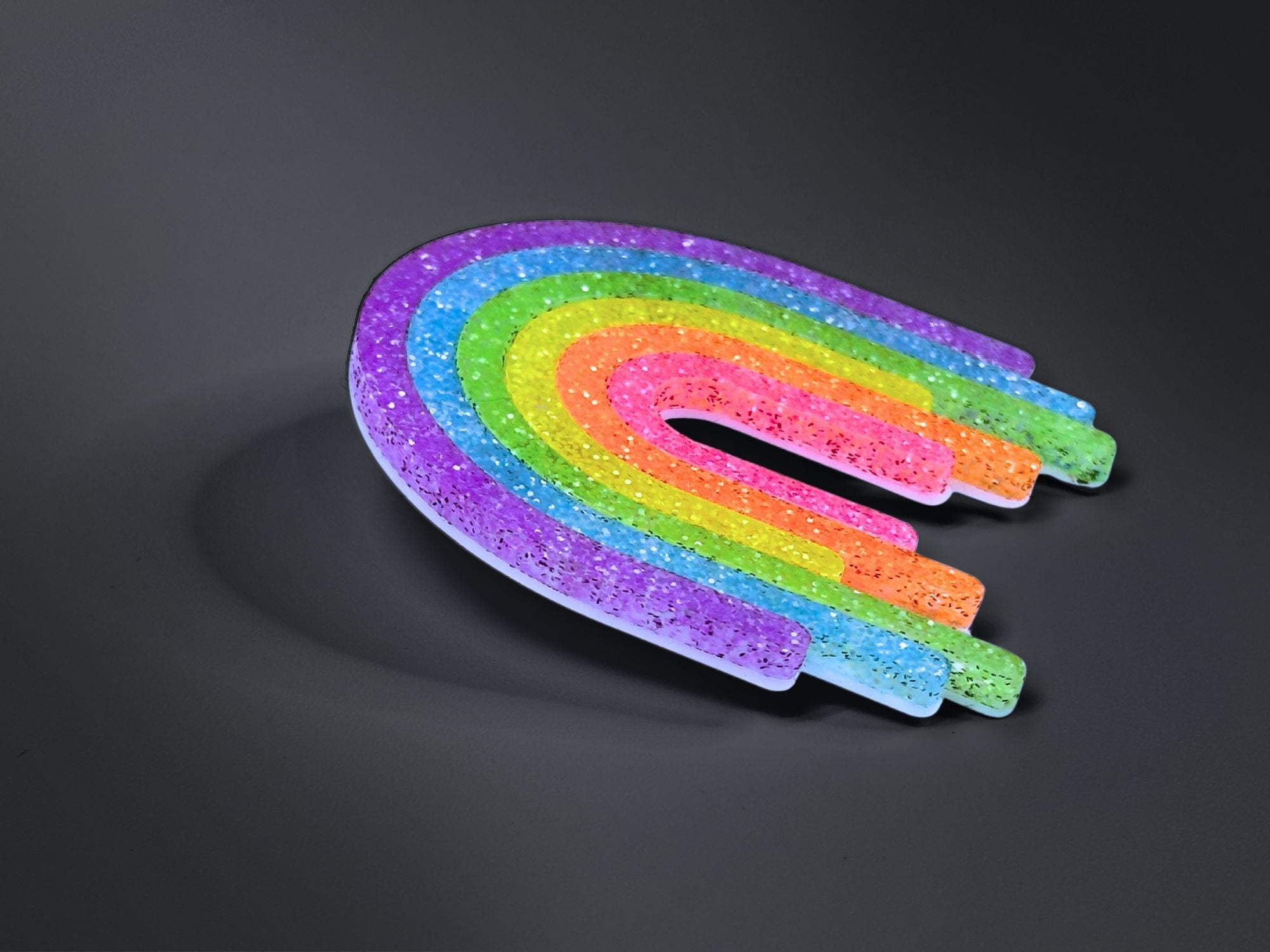 Full Spectrum Rebel Rainbow Rave drip brooch in layered glitter acrylic on dark gradient background.