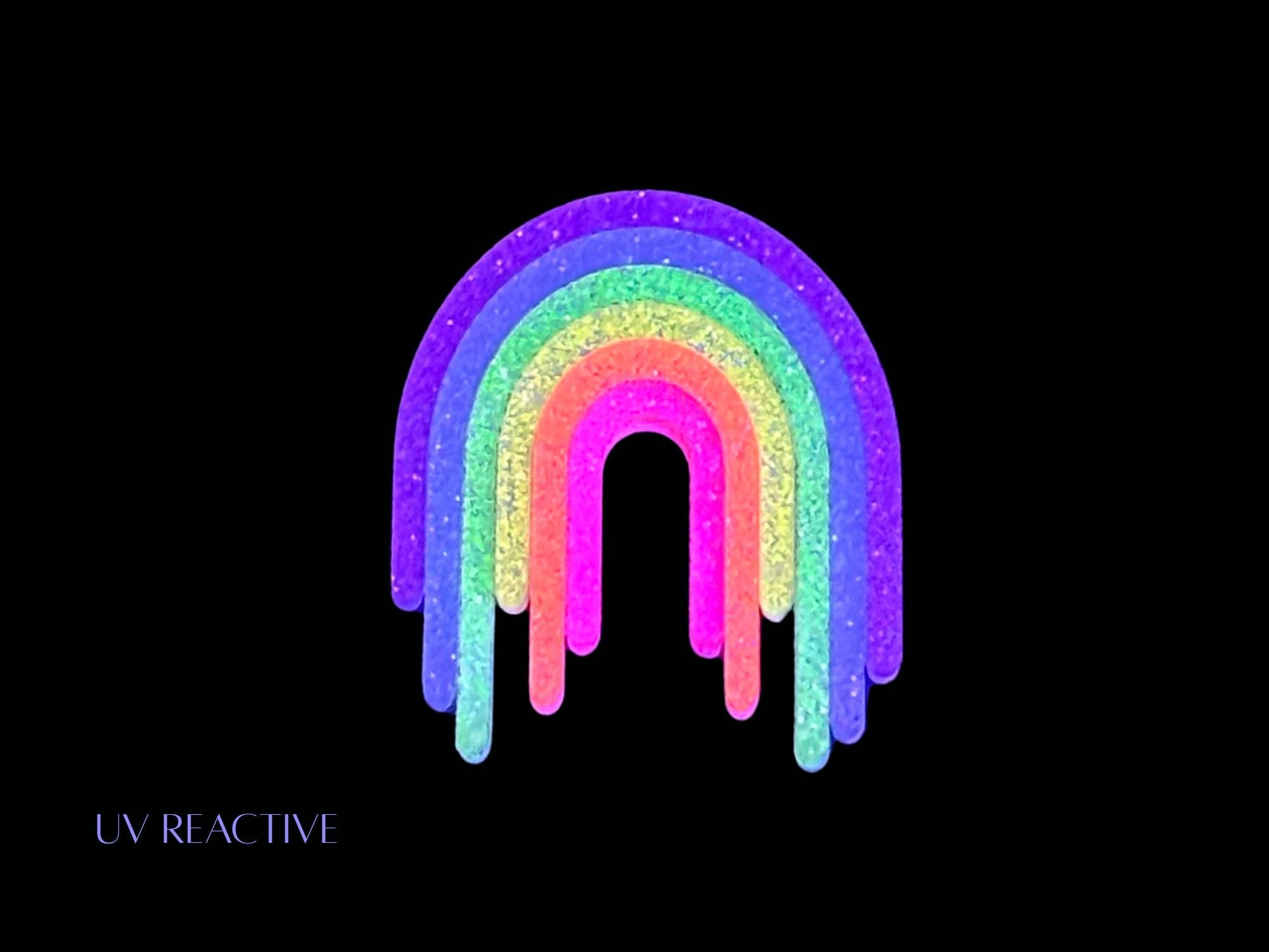 UV reactive Full Spectrum Rebel Rainbow Rave drip brooch editorial product image on black background.