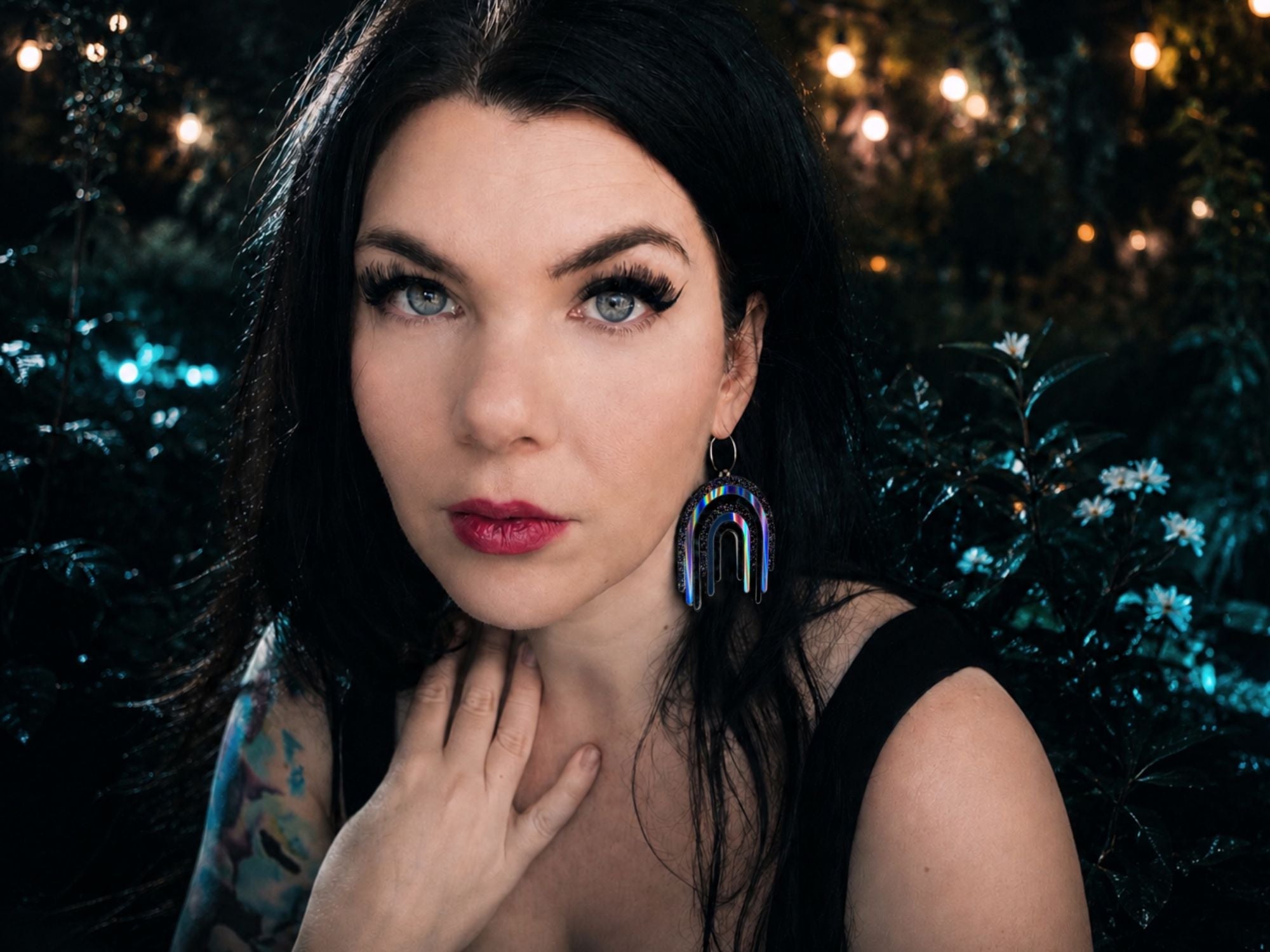 Model wearing Full Spectrum Rebel Drip Earrings in Black Rainbow colorway