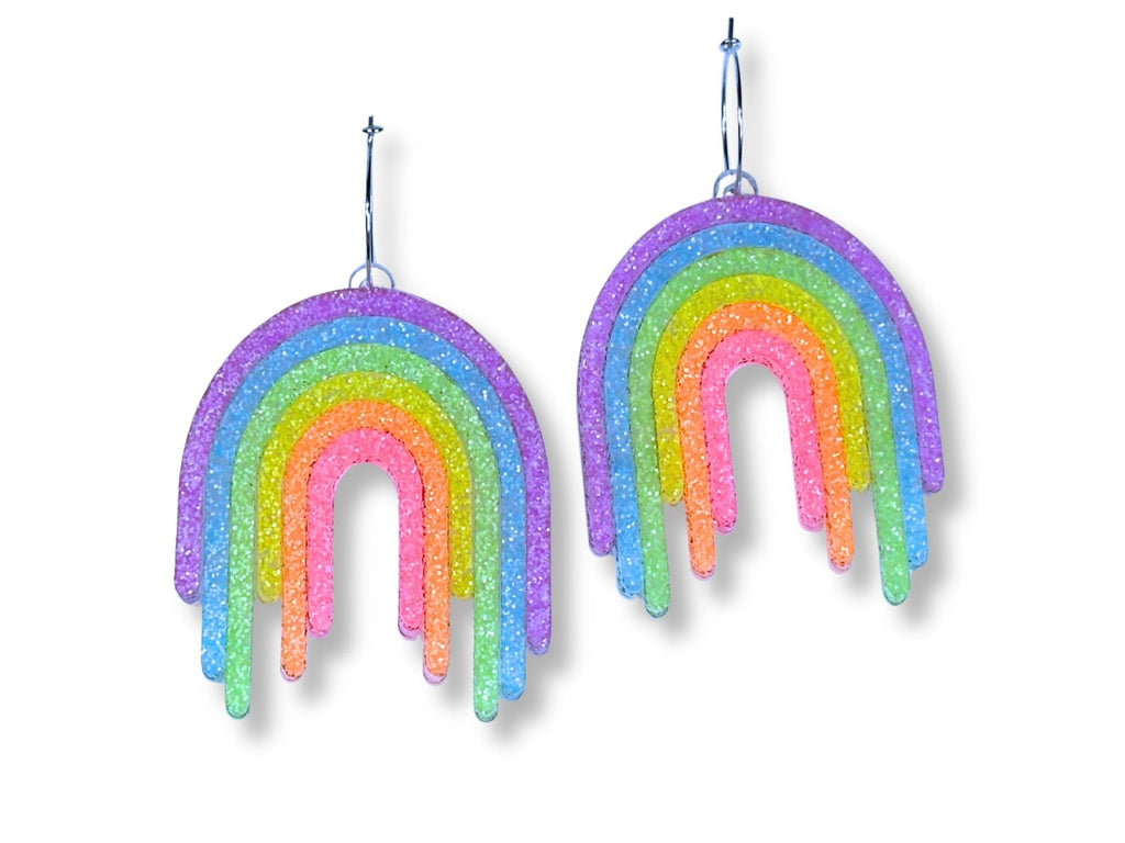 Full Spectrum Rebel Drip Earrings in Rainbow Rave glitter acrylic with silver hoop ear wires on white background.