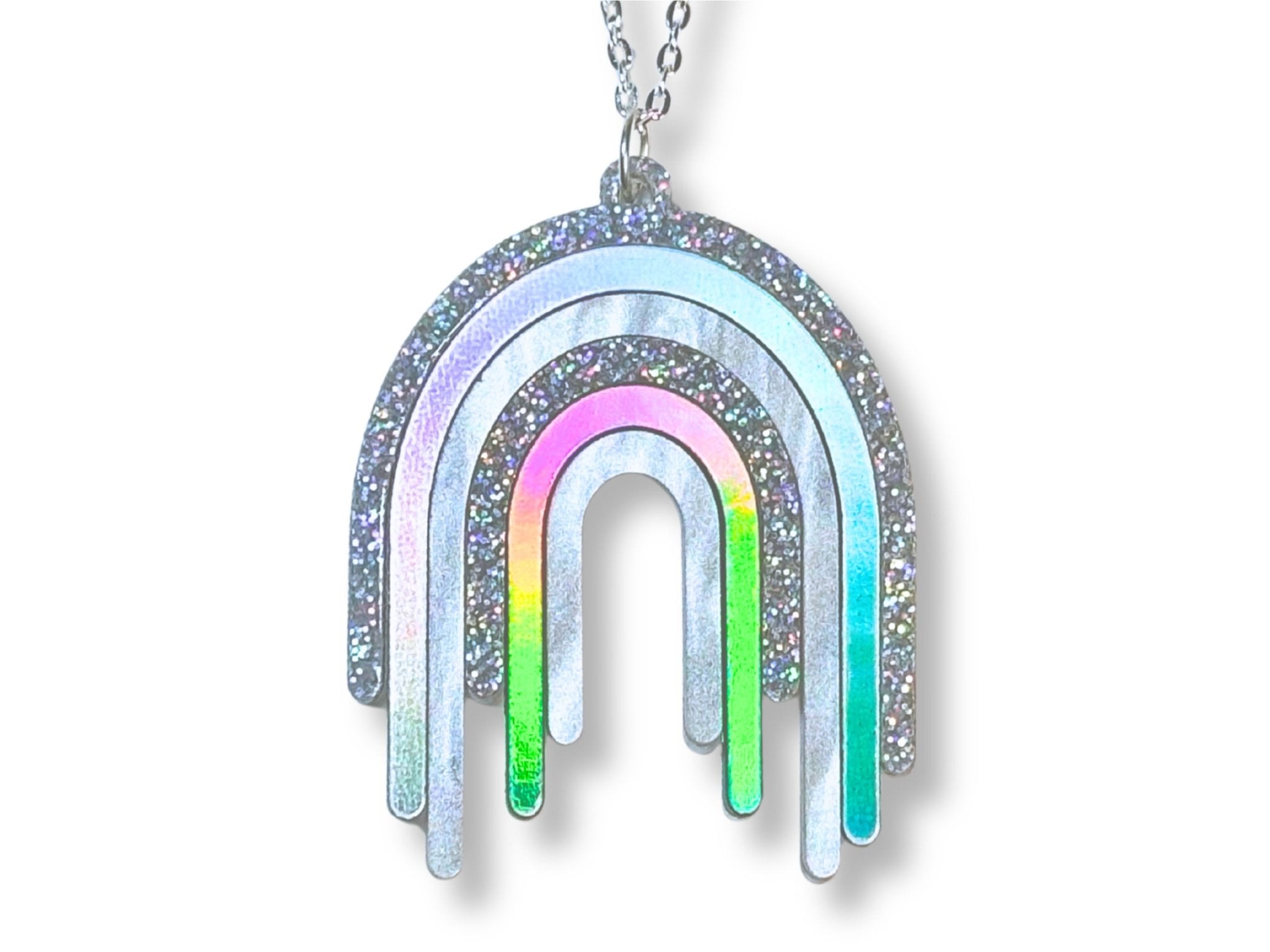 Disco Prism drip pendant necklace with layered silver, holographic glitter and iridescent rainbow arcs on a white background.