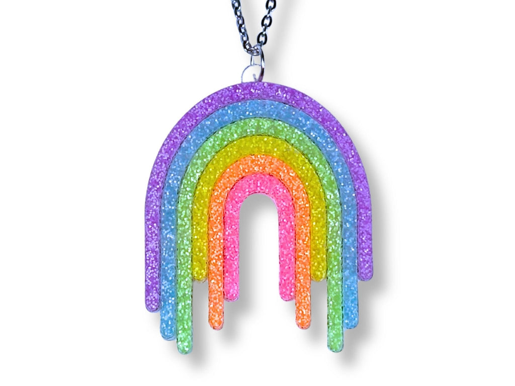 Full Spectrum Rebel Drip Pendant in Rainbow Rave glitter acrylic with silver chain on white background.