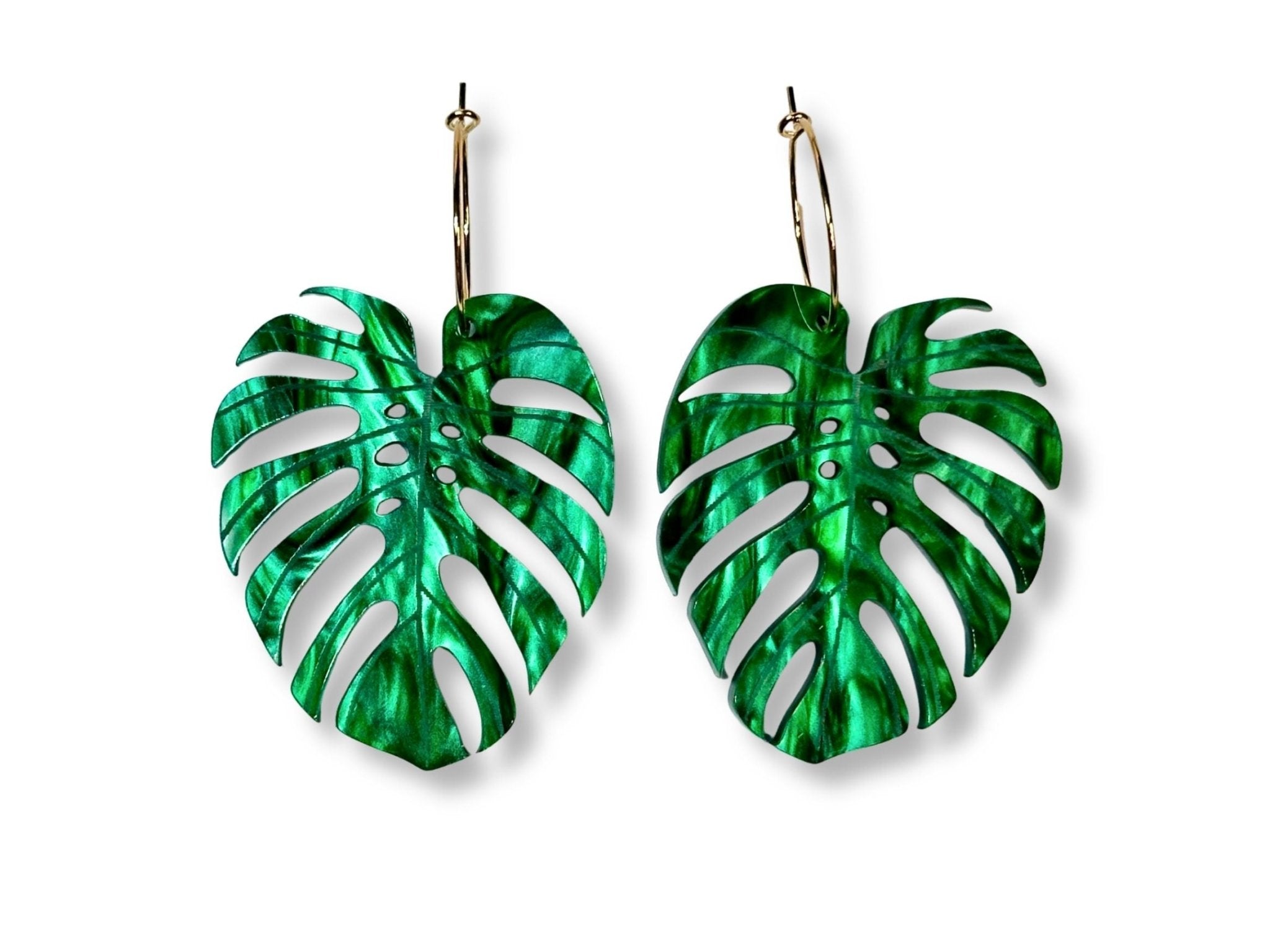Pair of green monstera leaf statement earrings with engraved vein details in pearlescent emerald acrylic on gold-tone hooks.