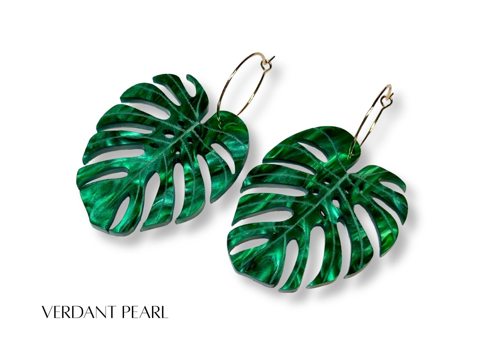 Verdant Pearl monstera leaf earrings in pearlescent green acrylic with engraved vein details.