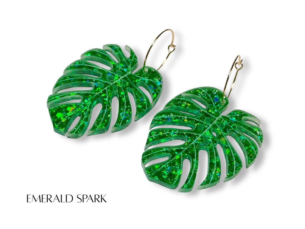 Emerald Spark monstera leaf earrings in glittering emerald green acrylic with engraved vein details.