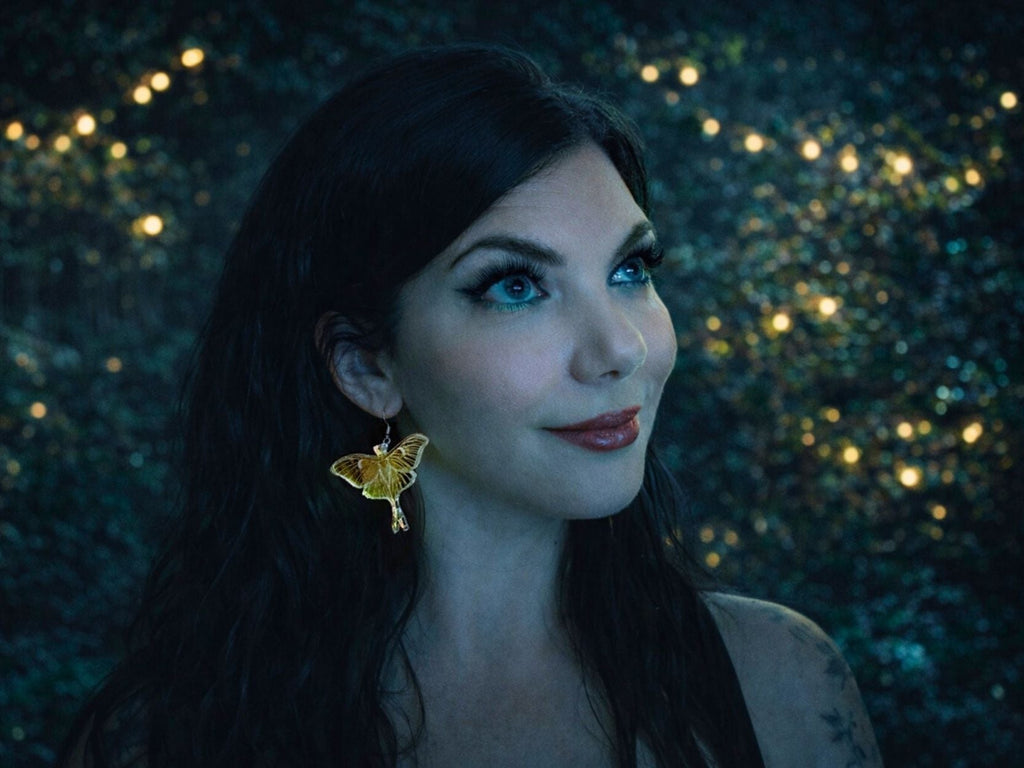 luna moth statement earrings worn on model large iridescent acrylic wings bold jewelry styling