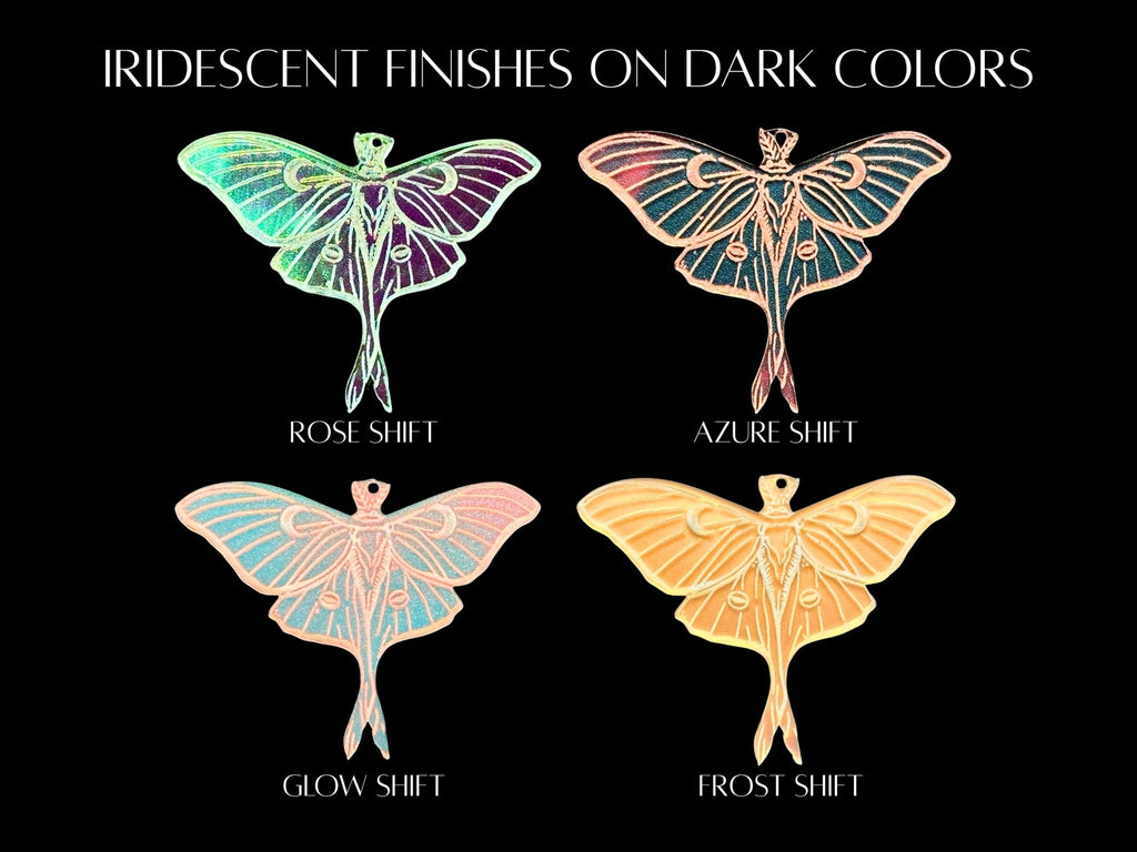 Color chart showing how the four available iridescent Luna moth earring finishes look over dark colors: Rosy Shift, Aqua Shift, Glow Shift, and Frost Shift.