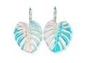Iridescent monstera leaf earrings with engraved tropical leaf details on silver ear wires against a white background.