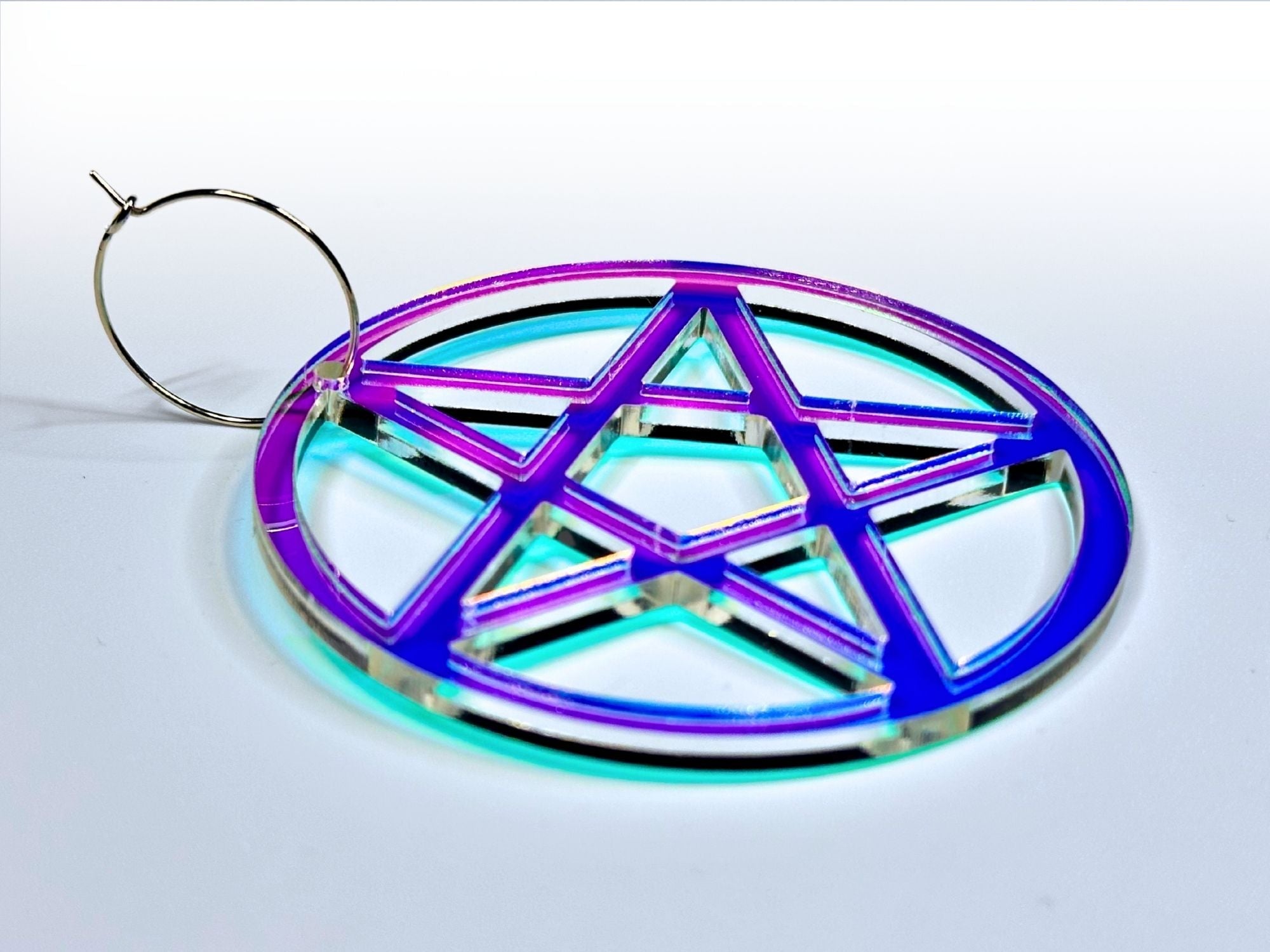 Side angle detail view of iridescent pastel pentagram acrylic hoop earring