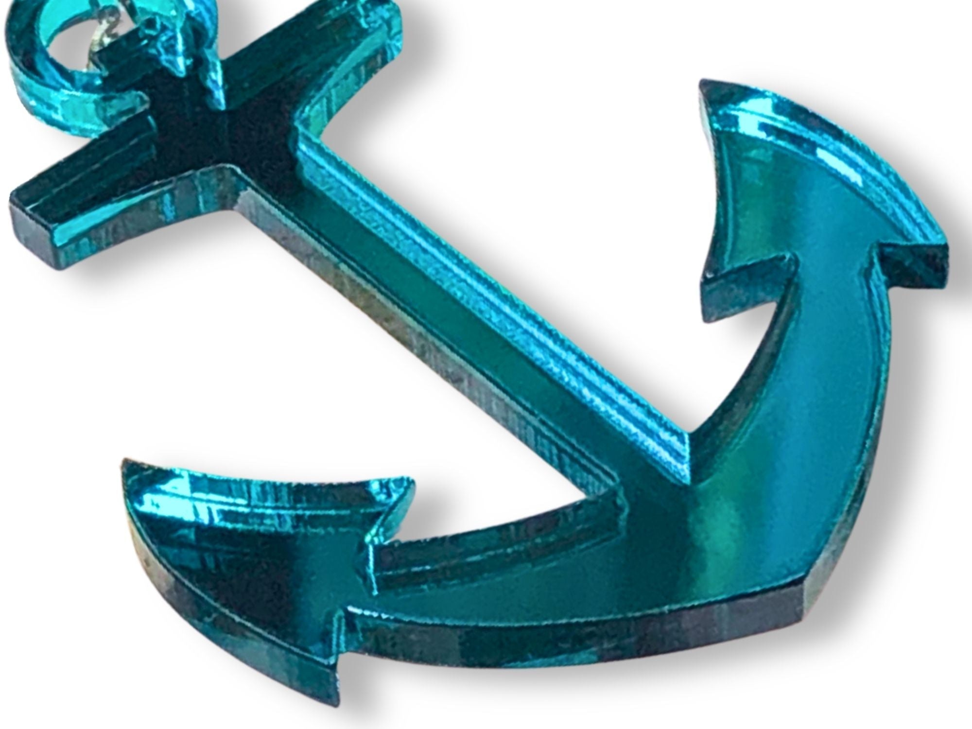 Close-up of turquoise mirror acrylic anchor earrings