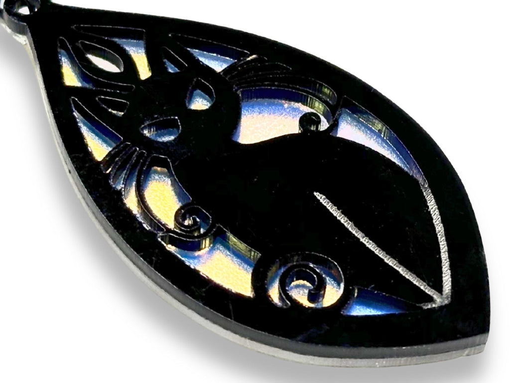 Close-up detail of original gothic cat earring design in black and iridescent acrylic