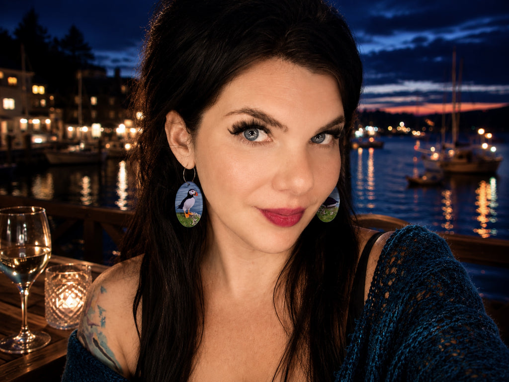 Model wearing Painted Raina puffin earrings with original bird artwork