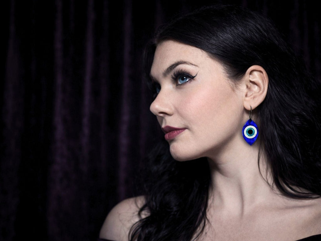 evil eye earrings worn on model bold statement talisman jewelry styling